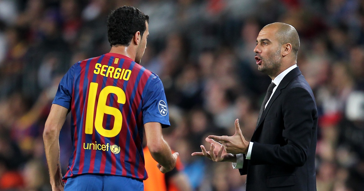 Pep Guardiola gives instructions to Sergio Busquets