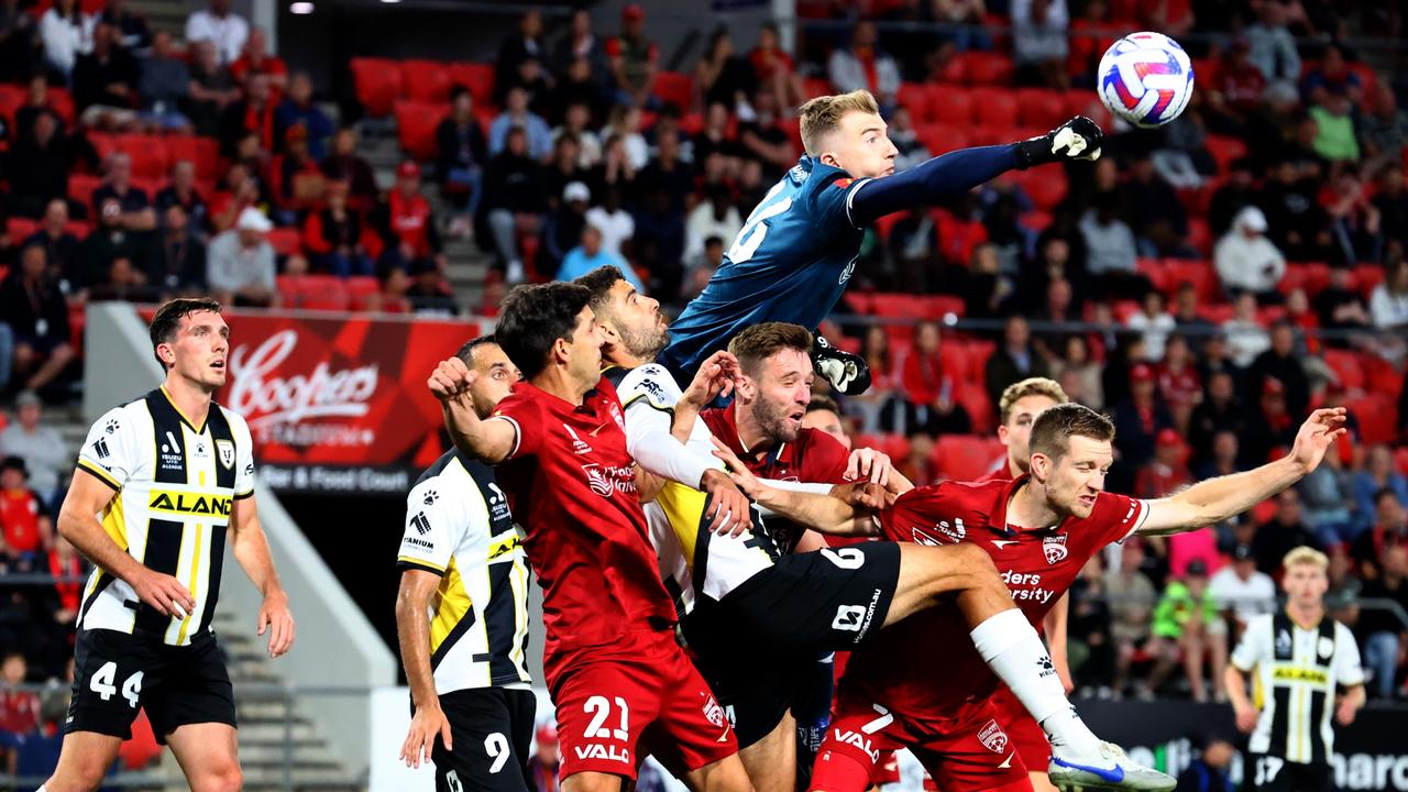 Goalkeeper Joe Gauci of United punches the ball away. Picture: Kelly Barnes