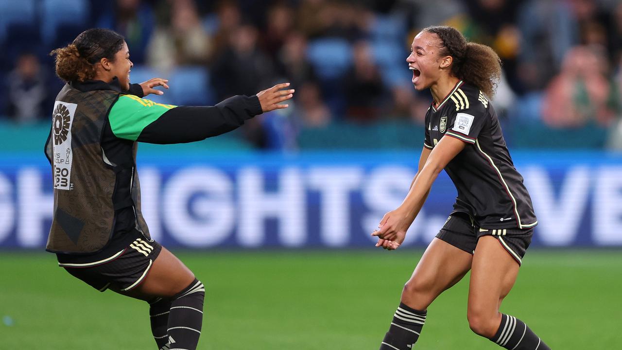 Peyton McNamara and Solai Washington of Jamaica celebrate the draw.